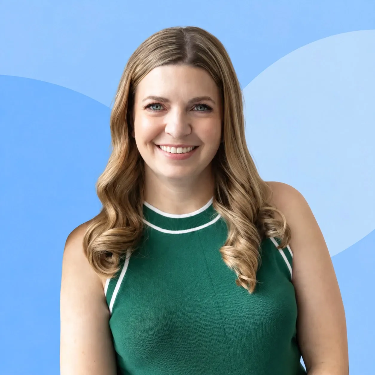 Dr. Meagan Peek, smiling, with long blonde hair and a green sleeveless top, against a pale blue background.